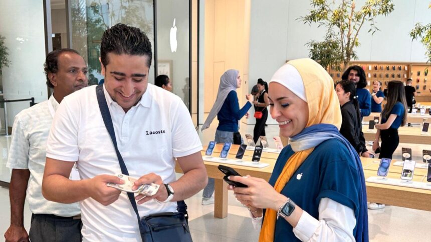 Tourists holding iPhone 15 at Apple UAE Launch